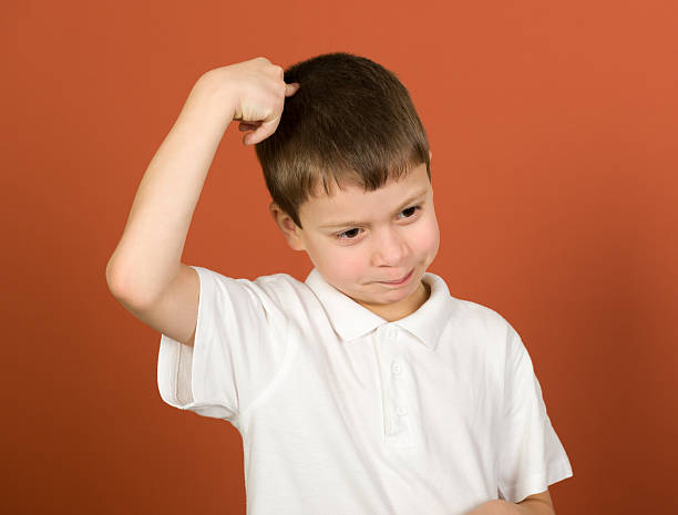 istock grimacing boy portrait on brown 528983299