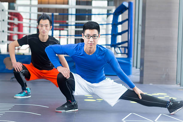 istock young asian men doing yoga in modern gym 528983316