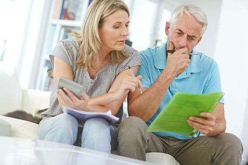 Shot of a mature couple working with their home finances