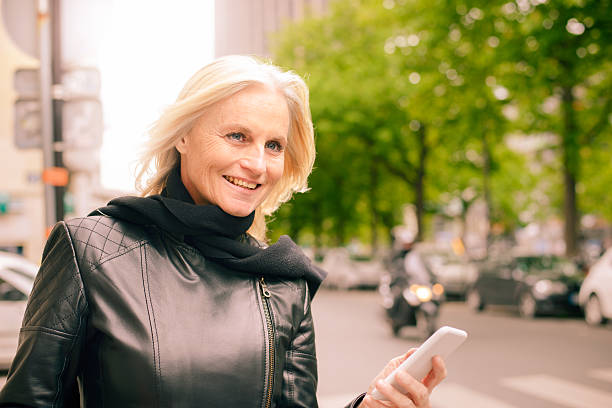 istock Mature Woman Using Smartphone App for Taxi Service 528983588