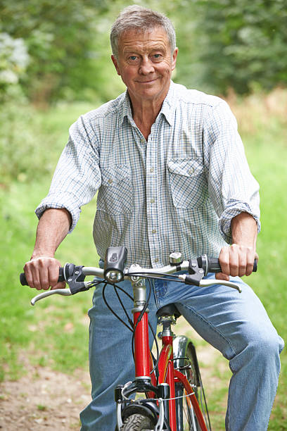 istock Senior Man Enjoying Cycle Ride In The Countryside 528983653