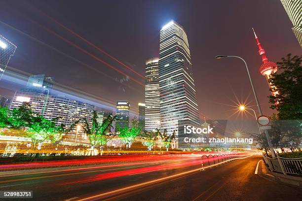 The Light Trails On The Modern Building Background In Shanghai Stock Photo - Download Image Now