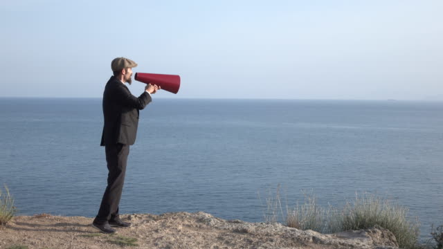 Adult Man Shouting Via Old Fashioned Megaphone In Outdoor