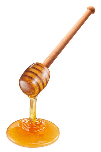 Honey flowing from wooden stick on white background. Clipping paths.