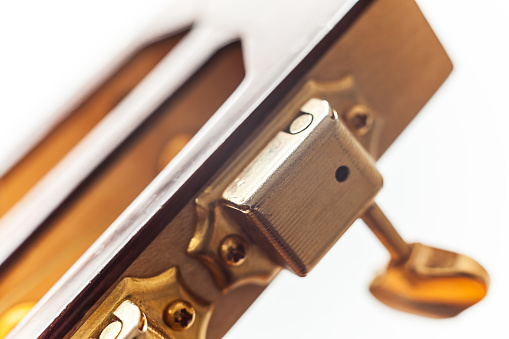 Part of a gipsy guitar, old fashioned acoustic guitar in macro view.