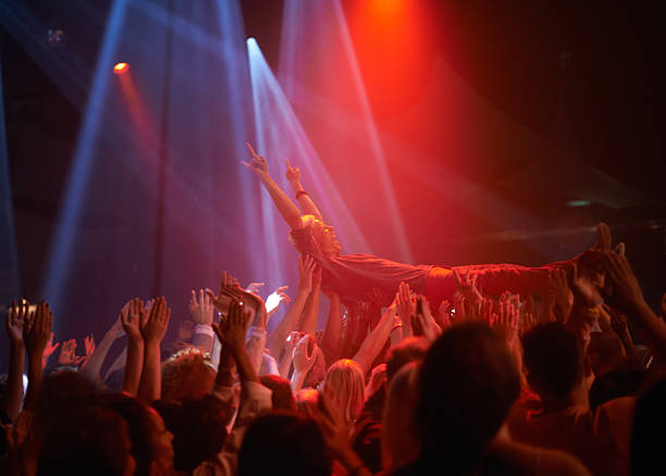 Surfing on a crowd of fans A stage diver being carried across the audience at a rock concert dubstep photos stock pictures, royalty-free photos & images