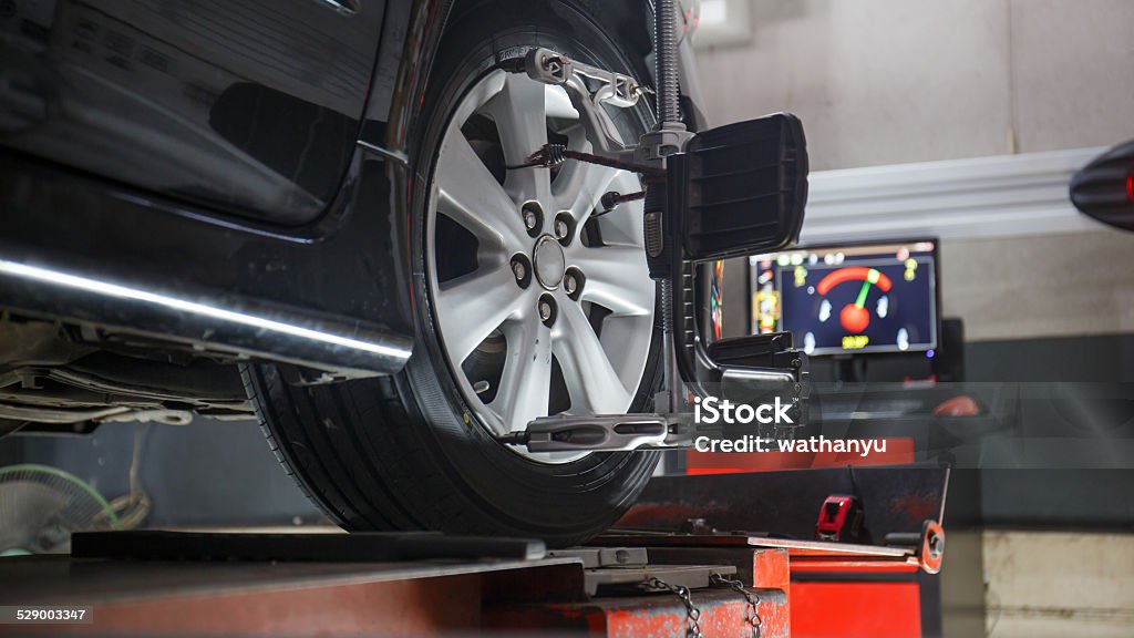 wheels alignment camber Car on stand with sensors on wheels for wheels alignment camber check in workshop of Service station. Order Stock Photo