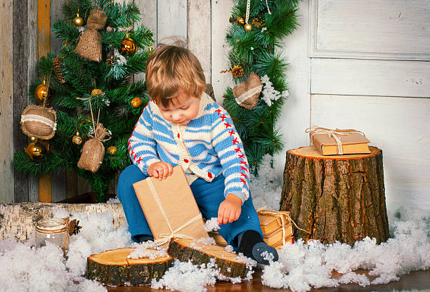 istock Little boy holding his christmas present 529003665
