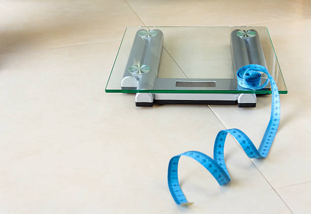 istock Weight scale and tape measure on bathroom 529004771
