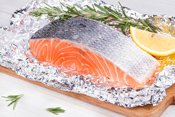 istock Fresh salmon ready for cooking on the foil paper 529004879