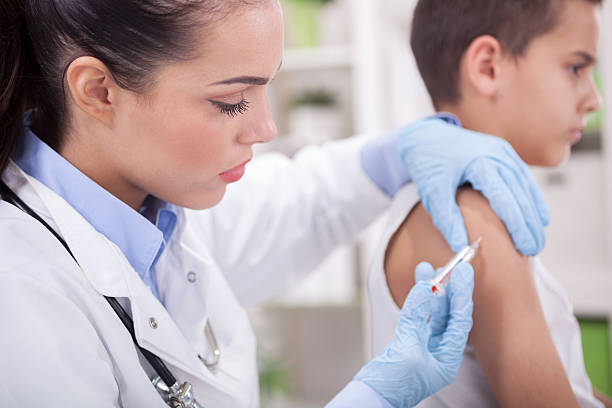 istock boy is scared doctor making vaccination to the litle child 529006319