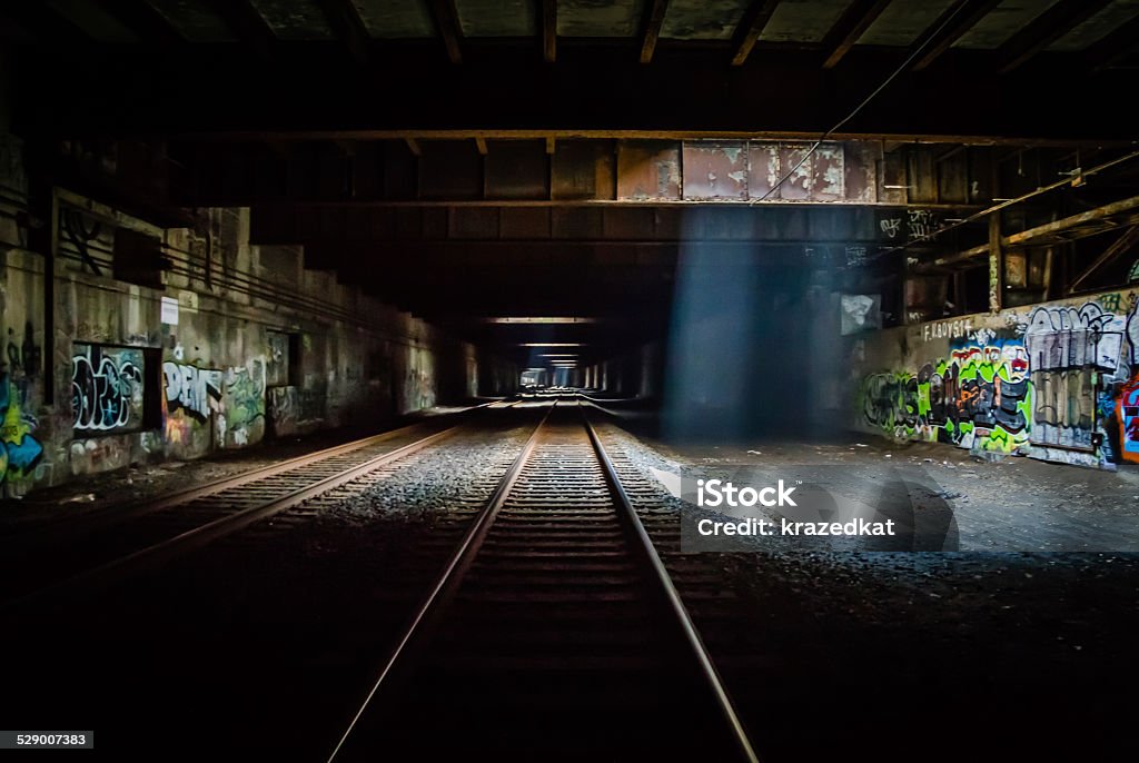 Grunge Dark Train Tunnel Grunge Train Tunnel with light beams, graffiti and dark overtones Abandoned Stock Photo