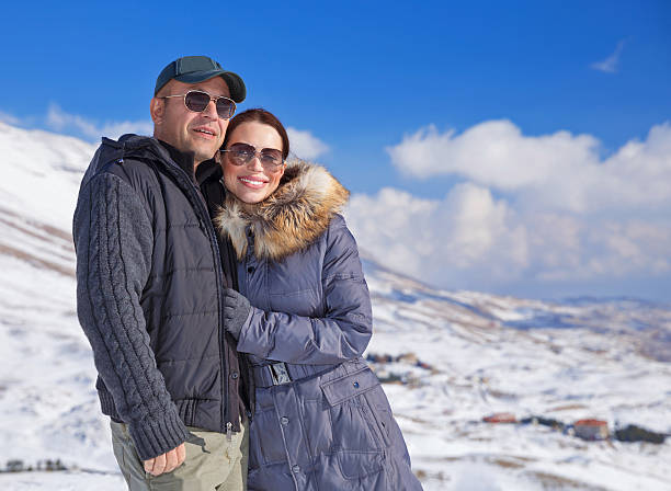istock Loving couple in snowy mountains 529007395