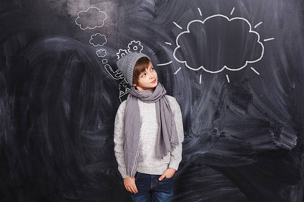 istock The boy looks at a cloud drawn on the chalkboard 529008175