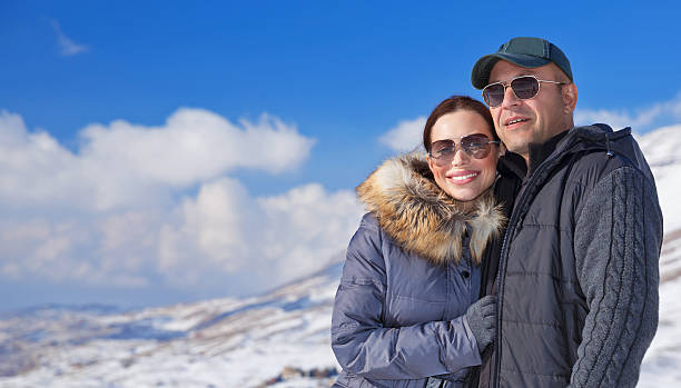 istock Happy travelers in snowy mountains 529008681