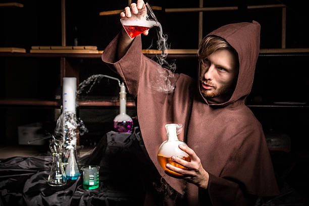 istock Alchemist in chemical laboratory prepares magical liquids 529025247