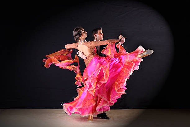 istock dancers in ballroom against black background 529029037