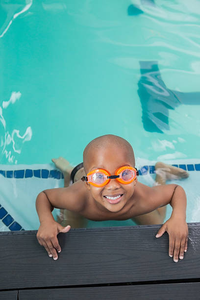 istock Cute little boy smiling up at the pool 529029571
