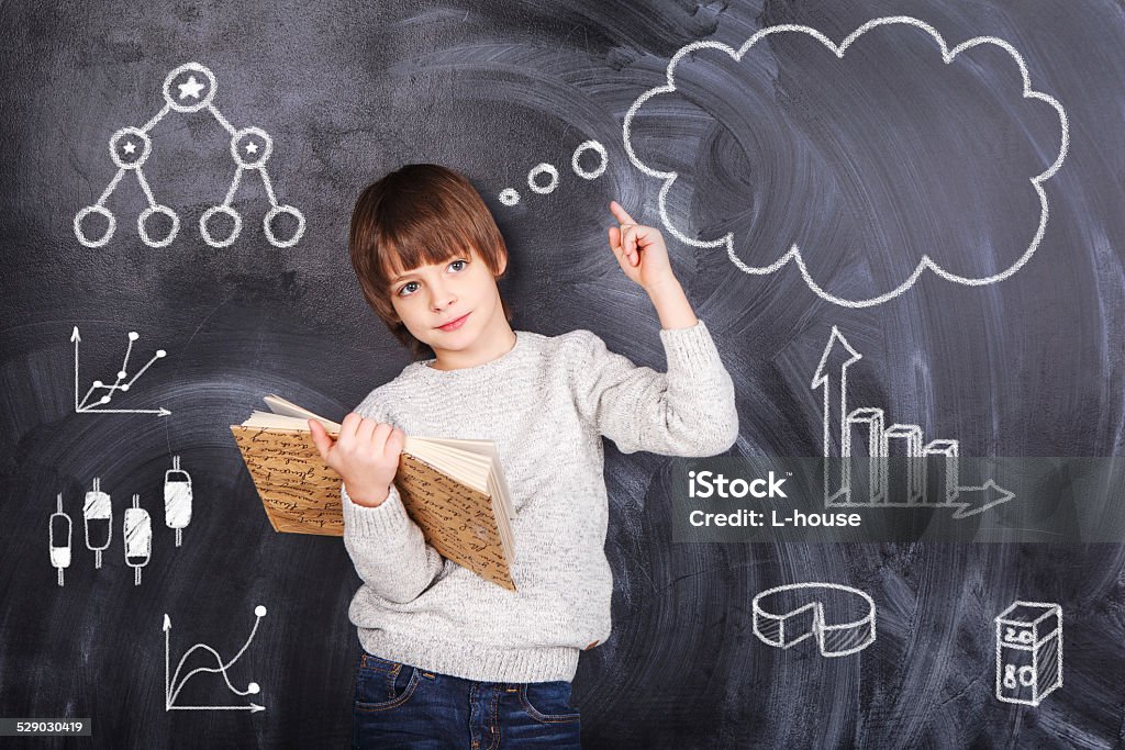Schoolboy prepare their homework Thoughts of children against the black chalkboards Child Stock Photo