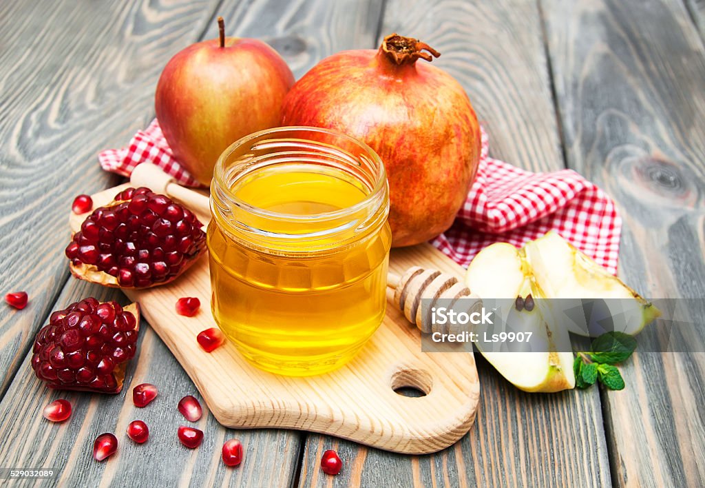 honey apple and pomegranate honey apple and pomegranate on wooden table Apple - Fruit Stock Photo