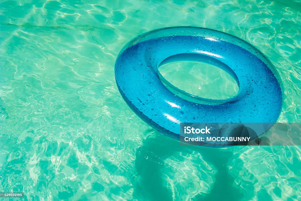 Inner tube in swimming pool. Inner tube floating in swimming pool. Blue Stock Photo