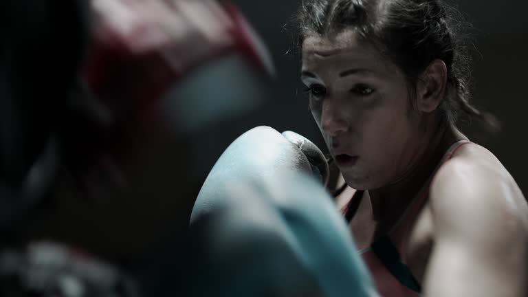 Female Boxer pad work session with trainer