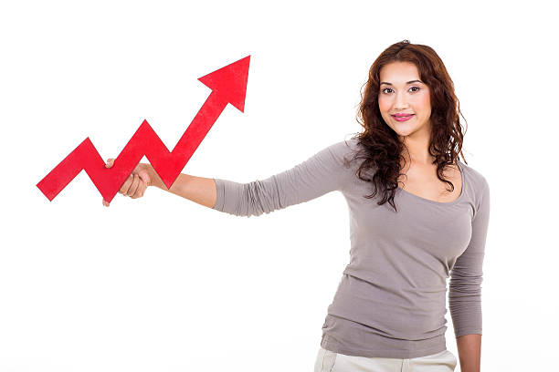 istock woman holding red growing arrow 529049039