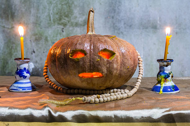 istock Halloween still life with pumpkins, candles and rosary 529049895