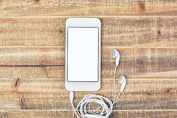 istock White smartphone with headphones 529051860