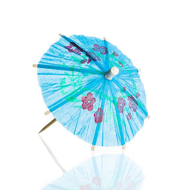 istock blue cocktail umbrella isolated against white background 529051868