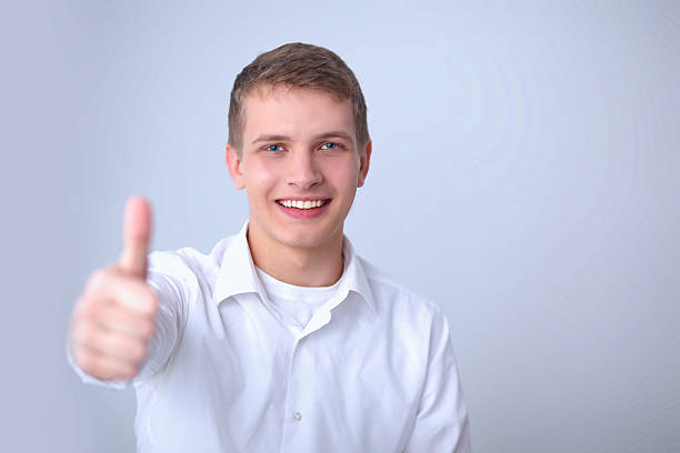 istock Happy man showing ok, isolated on gray background 529052387