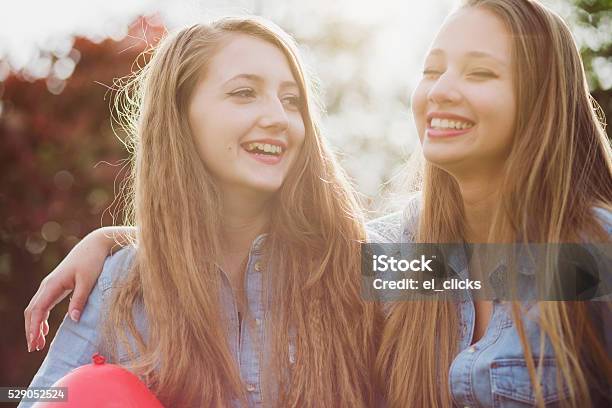 Smiling Teenagers With Red Ballon Stock Photo - Download Image Now - Friendship, Teenager, UK