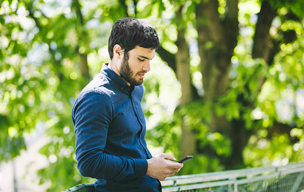 istock Young Man in City Nature with Smartphone 529052588