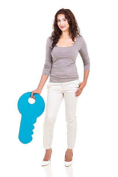 istock young girl with a large key symbol 529053383