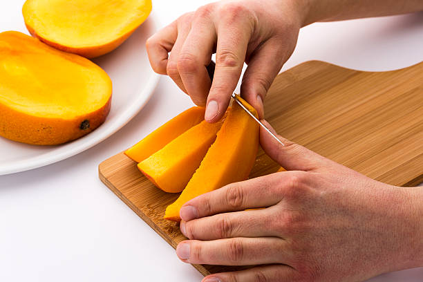 istock Peeling Away The Mango Skin From A Fruit Chip 529053609