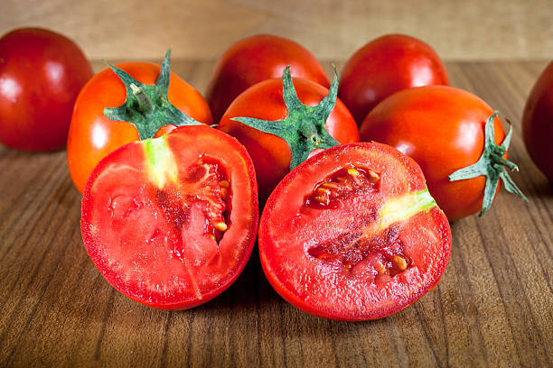 istock Close-up fresh ripe tomatoes on wood background 529054026