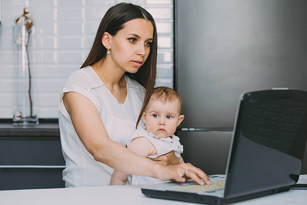 istock Mother with her daughter sit at the laptop. 529054104