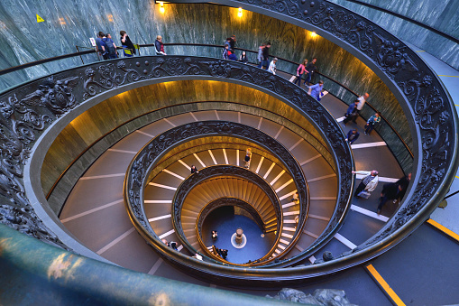 Rome, Italy - October 26, 2015: The famous and old spiral staircase. that leads to the exit of the vatican museum inside the vatican city. The Vatican Museums are among the greatest museums in the world.