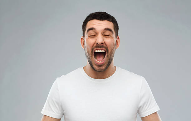 istock crazy shouting man in t-shirt over gray background 529056390