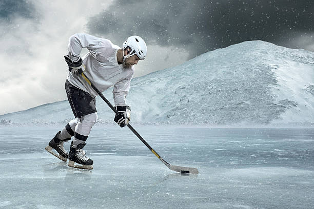 istock Ice hockey player on the ice in mountains 529056476