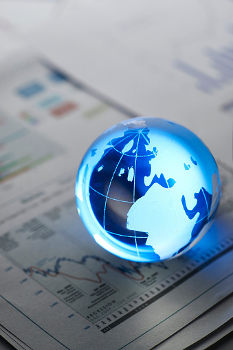 Glass globe on  stock market chart . shot with very shallow depth of field.