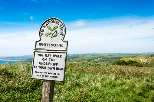 Ringstead, UK - May 8, 2016: An old National Trust sign post labelling 'Whitenothe' near Ringstead in Dorset. A popular location on the South West coastpath.