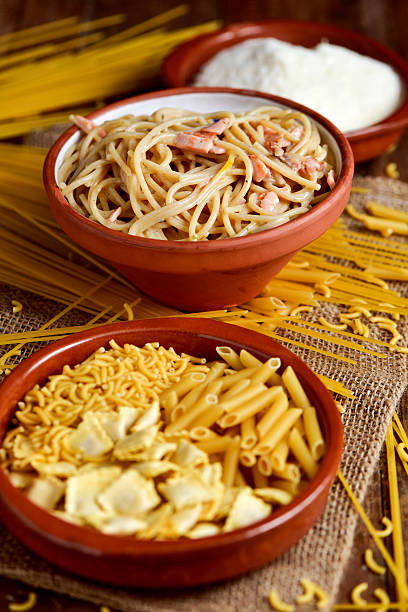 istock uncooked pasta, spaghetti alla carbonara and grated cheese 529057836