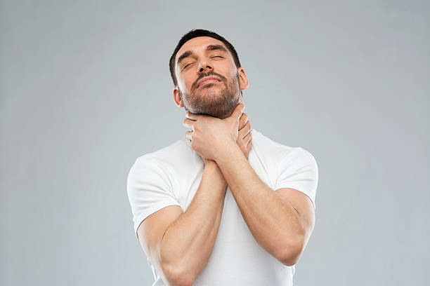 istock young man choking himself over gray background 529058420