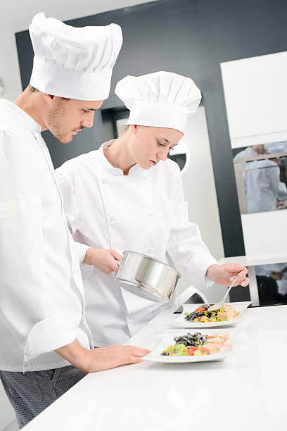 istock student and teacher in professional cook school kitchen preparing dish 529058816