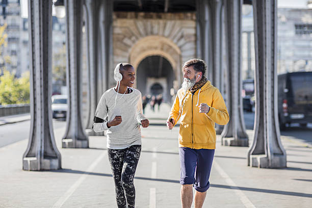 istock Senior man running with his personal coach in Paris 529061670