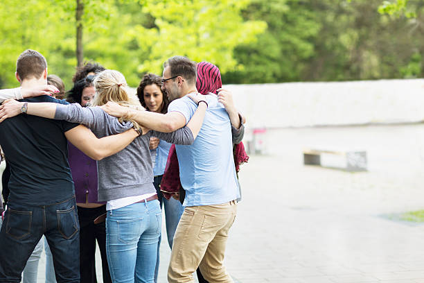 istock group of people togetherness embracing 529061864