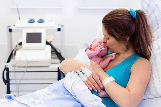 istock Young mother giving birth to a baby 529063142