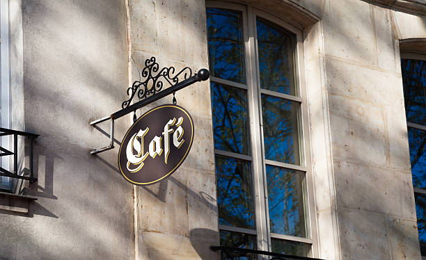 istock cafe sign and windows reflecting  trees in sunny Paris 529063624