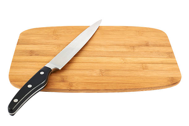 istock Knife over wooden cutting board 529064246